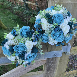 A wedding bouquet collection of ivory and teal flowers and foliage