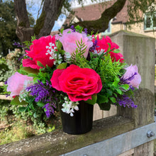 graveside artificial flower arrangement in shades of pink