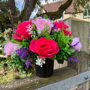graveside artificial flower arrangement in shades of pink