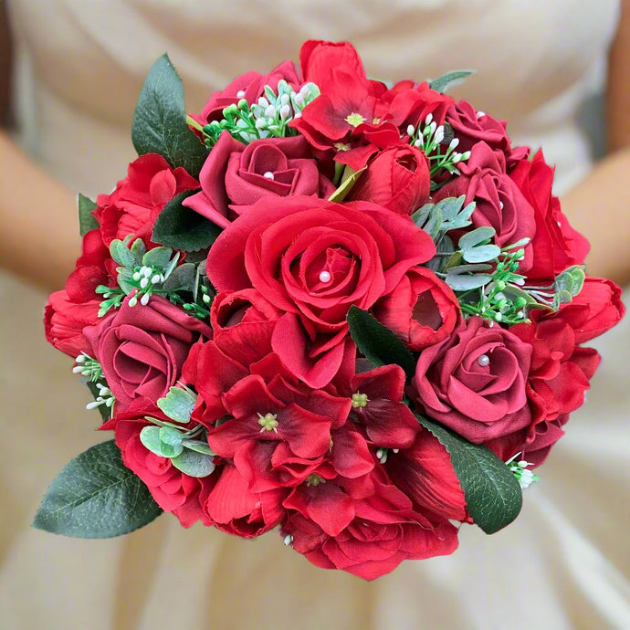 a wedding bouquet of artificial red silk roses & tulip flowers