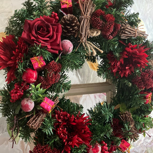 A large 45cm Christmas wreath with red decorations