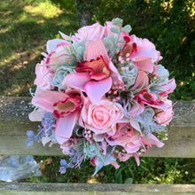 A wedding bouquet of coral and grey artificial roses and orchids