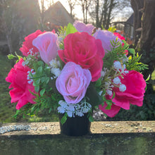 graveside artificial flower arrangement in shades of pink