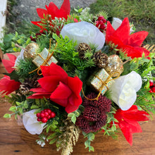 A Christmas red and gold memorial  arrangement in black pot