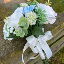 A brides bouquet of white/ivory and pale blue artificial silk flowers