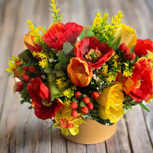 Gold hat box with artificial red and yellow flowers and berries