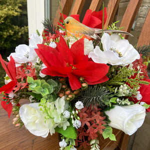 An artificial graveside flower arrangement in pot