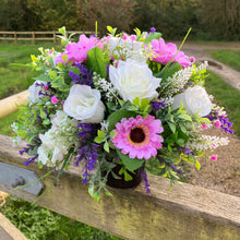 a graveside artificial flower arrangement in shades of cream and pink