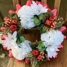 a memorial christmas wreath featuring parcels, cones and poinsettia