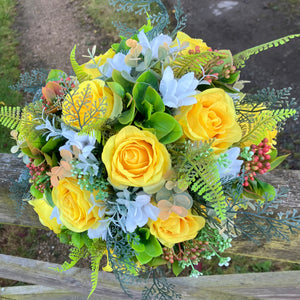 A brides bouquet of roses, peonies and fern