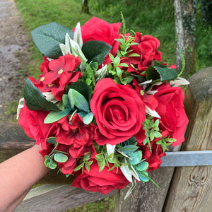 A wedding bouquet collection of artificial red flowers