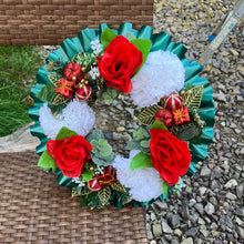 A christmas graveside memorial wreath of red roses and carnations