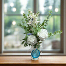 vase of artificial blue and white flowers