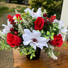 a christmas grave side pot with red & white flower arrangement