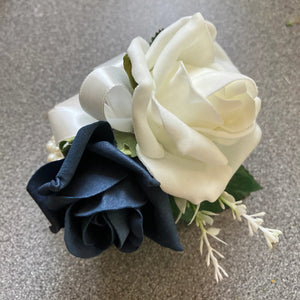 a wedding corsage featuring artificial flowers