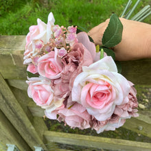 A wedding bouquet featuring silk  pink roses & peonies