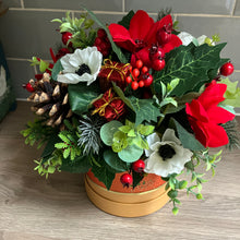 a christmas red & white flower arrangement in gold hat box