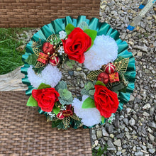 A christmas graveside memorial wreath of red roses and carnations