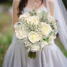 A wedding bouquet collection of ivory artificial silk roses and gyp