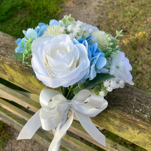 A brides bouquet of white/ivory and pale blue artificial silk flowers