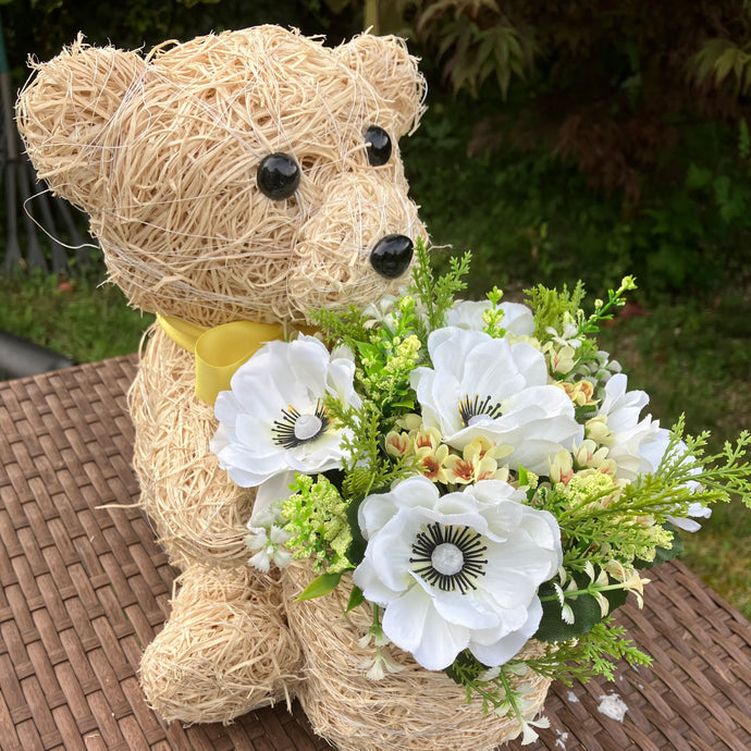 Child’s memorial teddy planter with yellow and cream artificial flowers