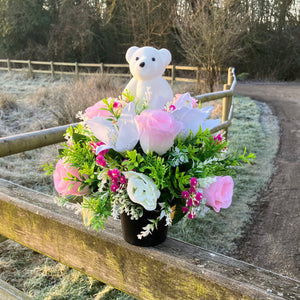 a grave pot with roses and lilies plus flocked teddy