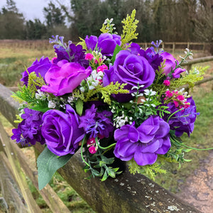 a silk graveside flower arrangement in black pot