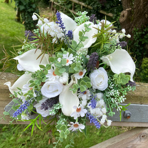 A brides bouquet of white calla, roses, lavender and foliage