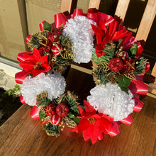 a memorial christmas wreath featuring parcels, carnations & poinsettia