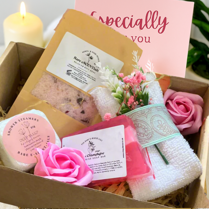 Gift box with bath products including soap, towel, and flowers, with a card reading 'Specially for you' in the background.