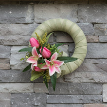 A sage green wreath with silk tulips and lilies