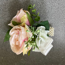 wrist corsage features blush pink silk rose flowers on pearl bracelet