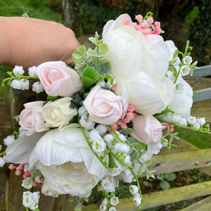 a brides bouquet of artificial silk ivory and pink peony & roses
