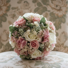 A wedding bouquet of ivory and dusky pink artificial flowers