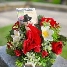 A graveside flower arrangement in black plastic pot