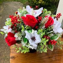 a christmas grave side pot with red & white flower arrangement