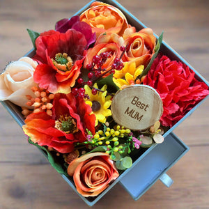 flower arrangement in grey hat box - orange yellow red