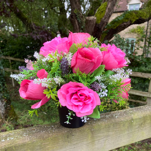 graveside artificial flower arrangement in shades of pink