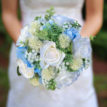 A brides bouquet of white/ivory and pale blue artificial silk flowers