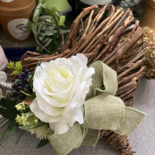 A heart wreath with faux roses and foliage