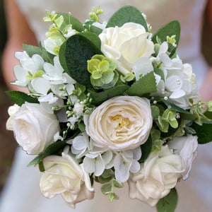 A teardrop bouquet collection of ivory roses, hydrangea and eucalyptus