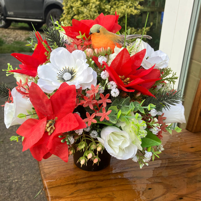 An artificial graveside flower arrangement in pot