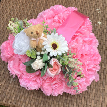 a personalised memorial heart of artificial silk roses and carnations in shades of pink