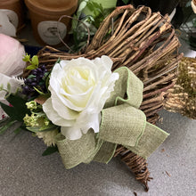 A heart wreath with faux roses and foliage