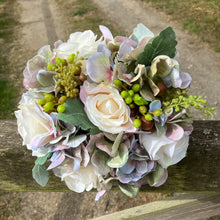 a wedding bouquet featuring artificial faux silk roses and hydrangea