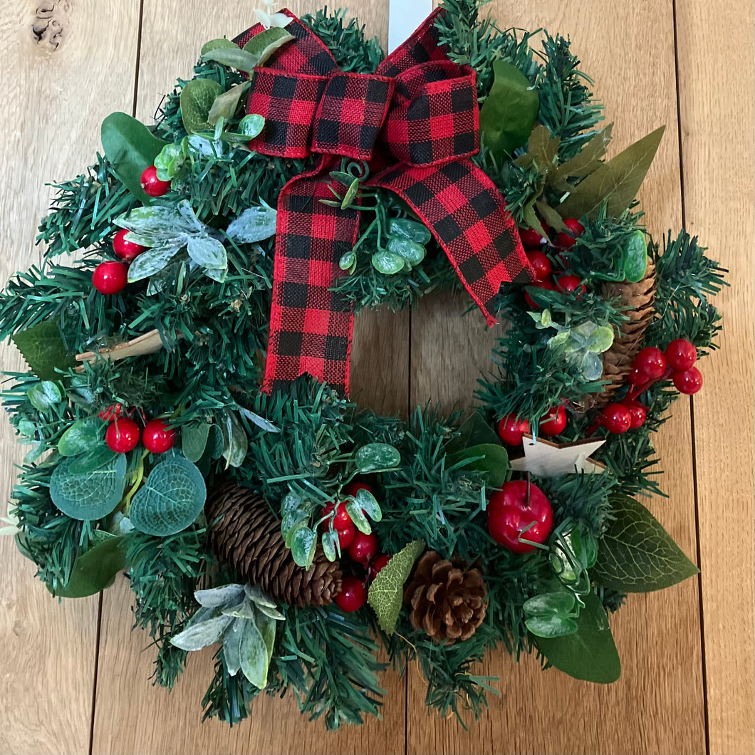 A 33cm pine Christmas wreath with artificial foliage, cones & berries