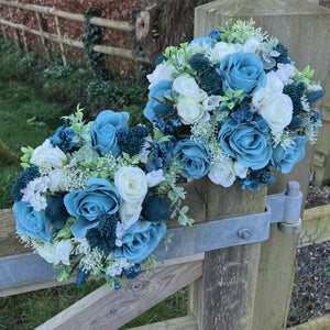 A wedding bouquet collection of ivory and teal flowers and foliage