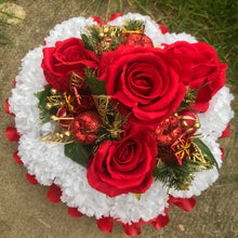 A christmas graveside memorial posy of red roses and carnations