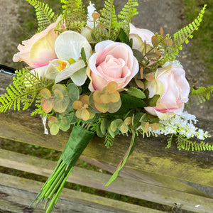 A brides bouquet featuring blush peach silk roses & orchids