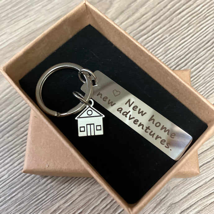 Stainless steel keyring with ‘new home, new adventures’ token